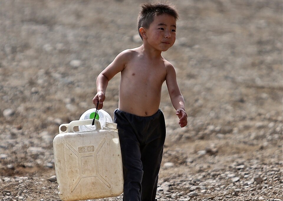 mongolian child getting water in Ulaanbaatar
